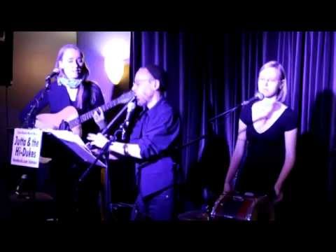 Three musicians on stage playing guitar, Bulgarian flute, and Bulgarian tupan on the Klezmer “Galicianer Tanz.” This is a still from a video of the Ensemble M’chaiya performing in concert.