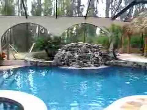 Inside Screened in Pool with Waterfall