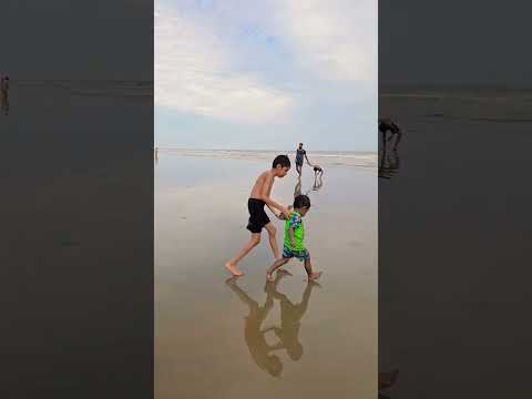 Mizan playing with sand at sea beach