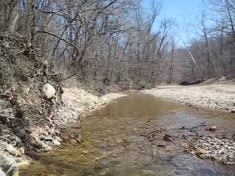 10 +/- Acres with Live, Babbling Creek! Versailles, MO.