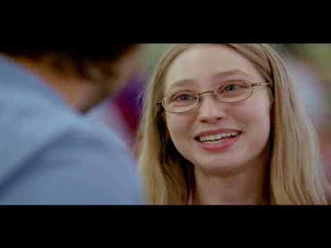 Trailer frame of neighbors gathered at the fence, echoing the film’s community-versus-isolation tension