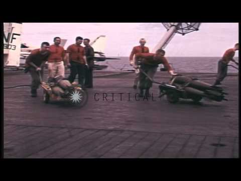 Aviation ordnancemen and marines arm  A-1H Skyraider aircraft aboard USS Ticonder...HD Stock Footage