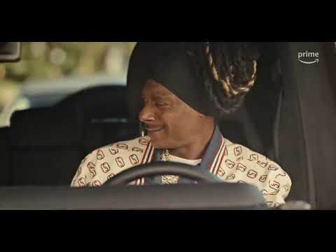 Prime Video trailer frame for The Underdoggs — Snoop Dogg’s coach strolling the sideline; hype-music energy