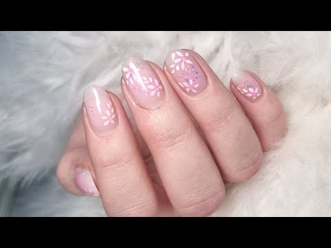 Blush nails with simple flowers and aurora glitter flakes.