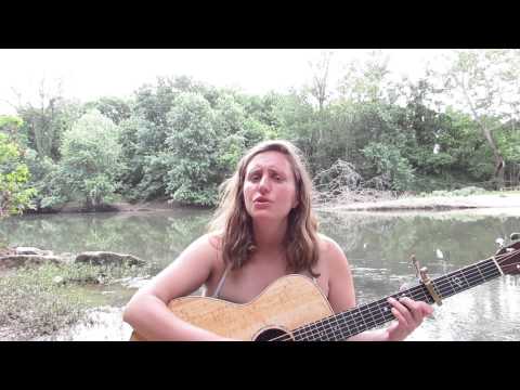 Erika Kulnys singing her song, The River Flows Onwards