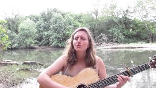 Erika Kulnys singing her song, The River Flows Onwards
