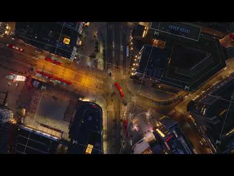 Top down ascending footage of transport node Jernbanetorget in evening. Trams and cars passing