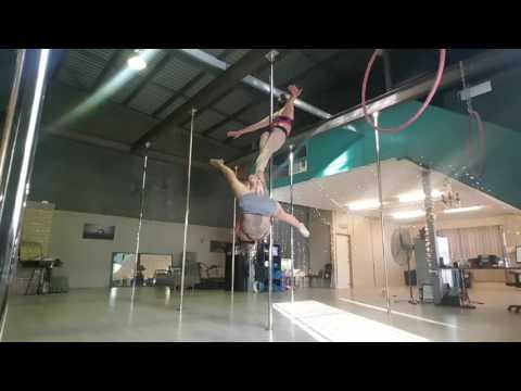 Two Girls Spinning On A Pole
