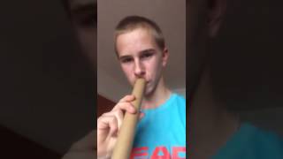 Christmas song played through wrapping paper tube