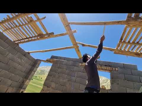 Continuing the process of building the roof of the house with boards in the village