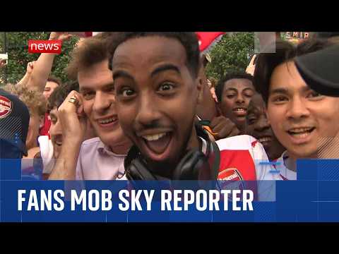 Arsenal fans gatecrash Sky News reporter's live broadcast