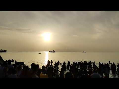 Group of people performing religious ritual prayers on the Rameshwaram beach