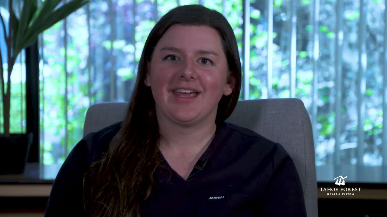 Kari Rezac, Sports Medicine Physician and Director of Sports Medicine, sitting in front of a window