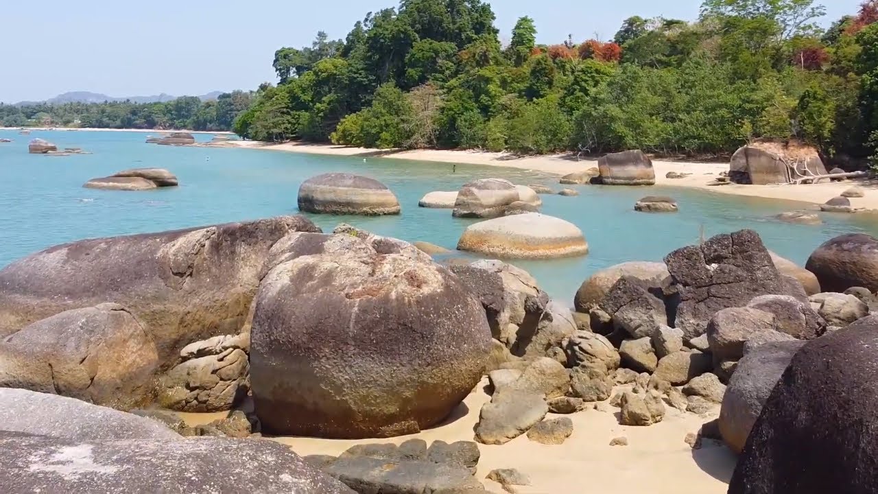 Discover the beauty of Pantai Pasir Hitam, featuring unique black beaches and serene waters