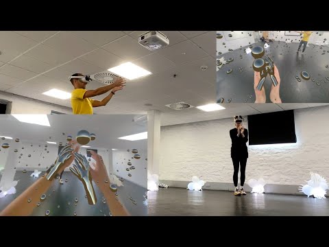 Two people standing with VR headsets taking part in Handu experience