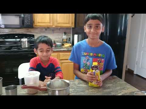 Arnav and Akshaj are making Chocolate Milk by using Nestle Nesquik Chocolate Syrup