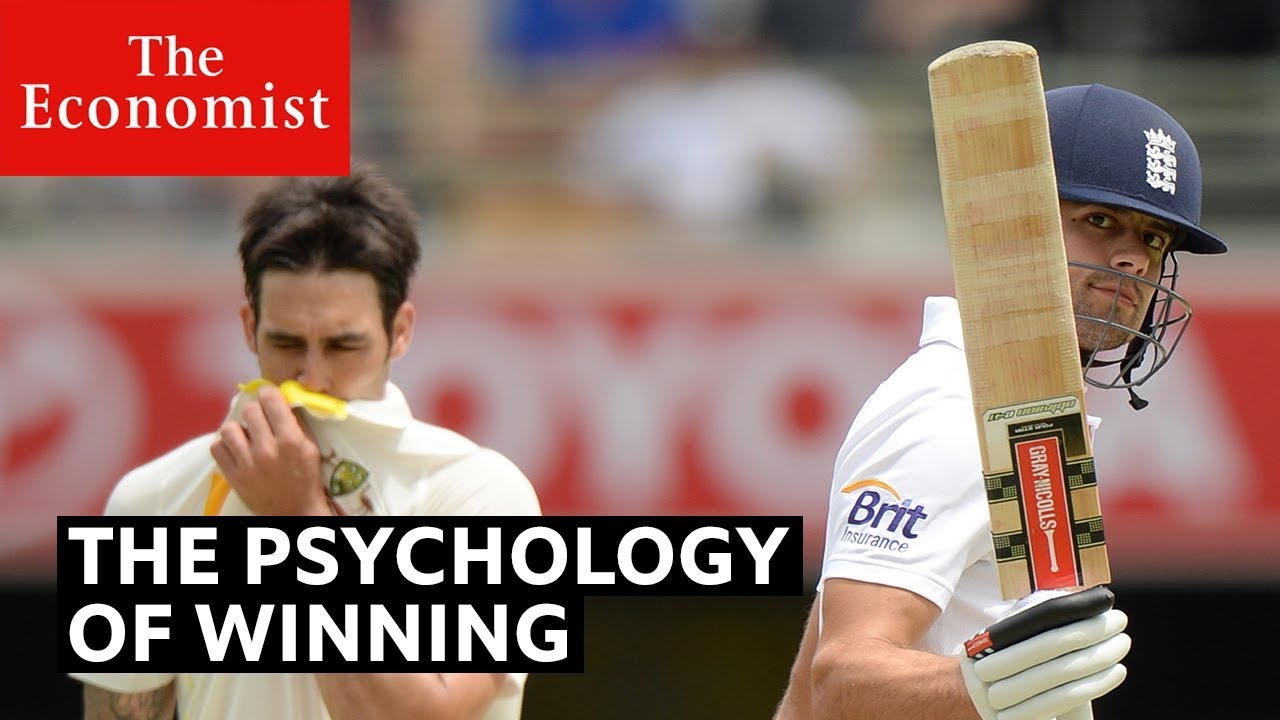 A cricketer in a helmet holds a bat up while another player hides his mouth under his collar. The Economist. The Psychology of Winning