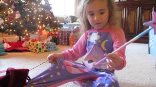 Christmas 2013. Finding her rainbow wand in the stocking.