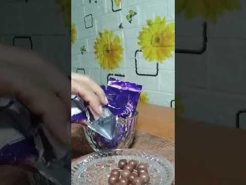 Pouring of chocolate balls/cadbury chocolate shots