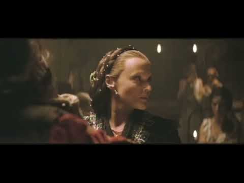 Trailer still — grand staircase Masquerade tableau with mirrored steps and monochrome masks