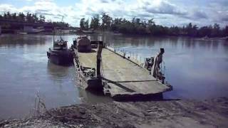 Loading a ferry barge to cross a Kamchatka river in Russia