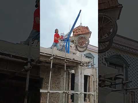 Hoisting Bricks to Rooftop with Crane