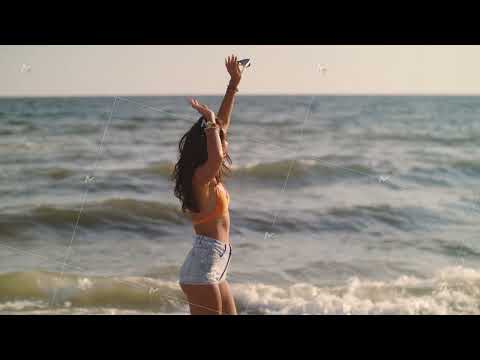 Young Woman Dancing Playfully on the Beach in the Sun in Slow Motion