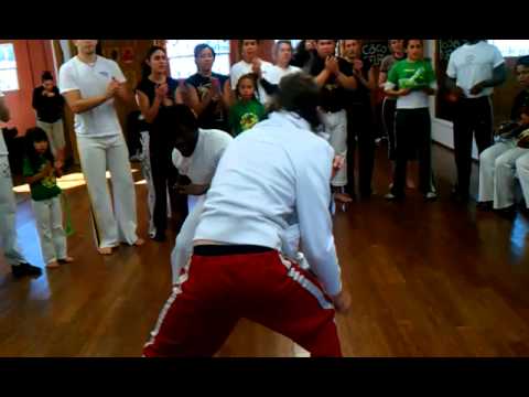 Two former marines in a Capoeira game  of combat .