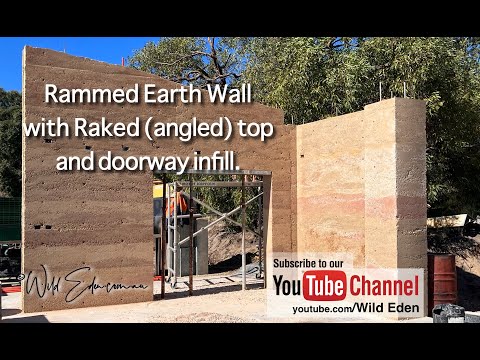 Unveiling Rammed Earth wall with Raked Top / Double Doorway Infill