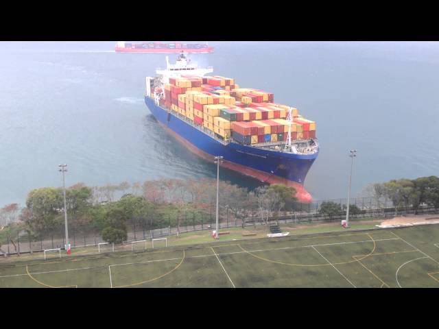 Container ship sails straight to shore by university football field
