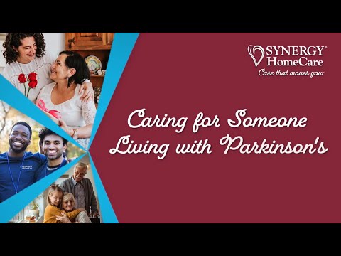 Senior woman in wheelchair enjoying time in the park with caregiver