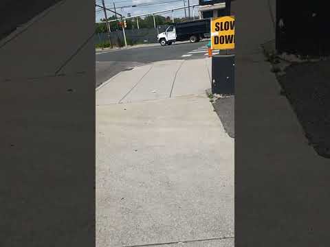 A Chevy Topkick Dump truck hauling a flatbed trailer