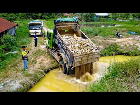 Bulldozer Power in action pour stone fall in ponf