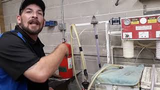 Paul servicing a fire extinguisher