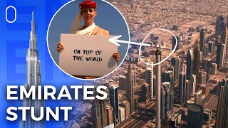 Emirates Flight Attendant Stands On Top Of The Burj Khalifa