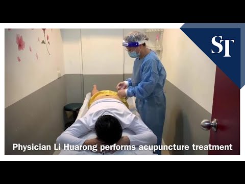 Physician performs acupuncture treatment on patient as Covid-19 circuit breaker curbs ease