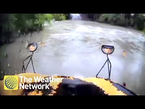 School bus swept away after driver tries to cross high water with child on board (on cam)