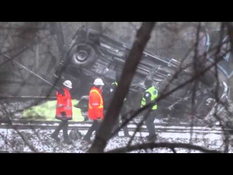 Truck crashes off overpass, hit by train below, killing two