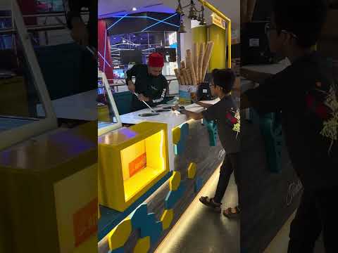 Me with the Turkish ice cream guy  in HiLite mall in India  (I broke the ice cream cone)