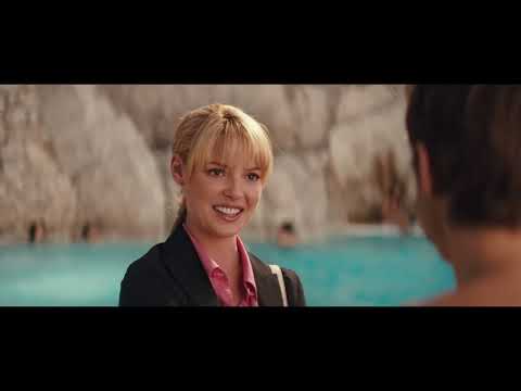 Trailer shot: cul-de-sac chase cutting to a cozy kitchen; the soundtrack toggles between caper stings and feel-good pop