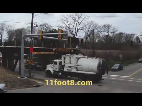 Industrial vacuum truck smashes into the 11foot8 bridge