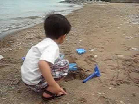 Aziz playing with sand and beach toys