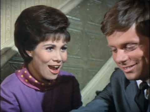 1967 film trailer frame referencing the Loesser score—Finch rides the corporate elevator