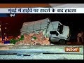 Vehicles collide while watching an over turned truck on a highway in Mumbai