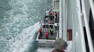 Cruise ship to small boat transfer of people while both are moving!