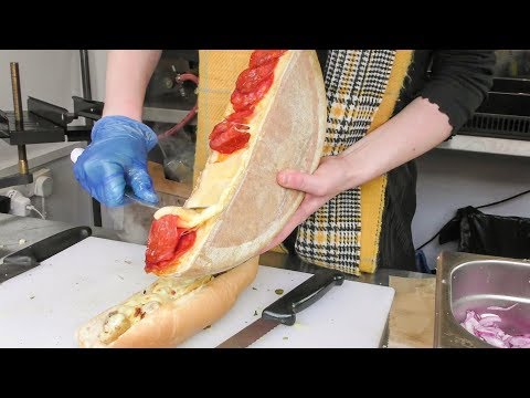 Swiss Raclette. Warm Melted Swiss Cheese with Chorizo Sausage and Serrano Ham. London Street Food