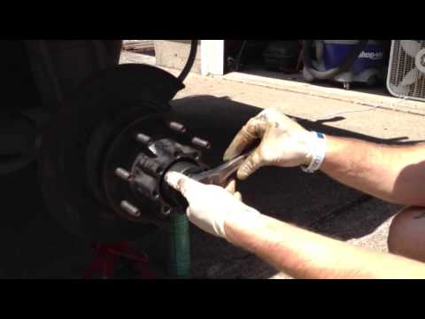 Removing rear left axle locking nut.