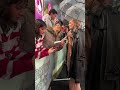 Signing in the rain... Margot Robbie meets fans at the "Wuthering Heights" UK Premiere