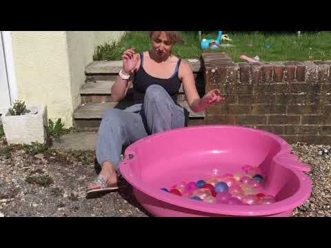 Popping 50 water balloons outside