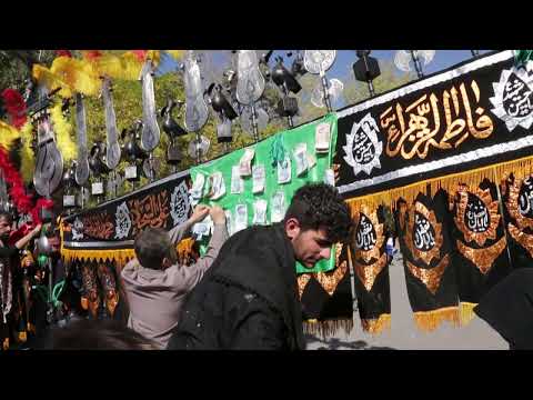 Iranian Shiite Muslim Man putting money on An Alam During Ashura, Bijar, Iran